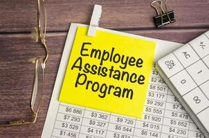 EAP Employee Assistance Program on yellow sticker and calculator and glasses photo