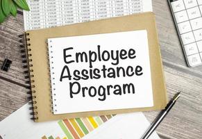 On the table charts, calculator and notebook with the EAP Employee Assistance Program. text photo