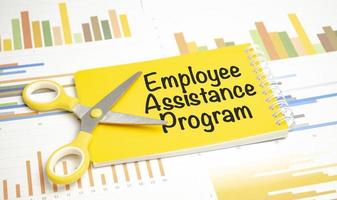 EAP Employee Assistance Program on yellow notebook and charts photo