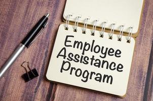 word EAP Employee Assistance Program text on white paper on wooden background photo