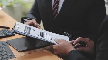 zaken en advocaten bespreken contractpapieren met koperen schaal op bureau in kantoor. wet, juridische diensten, advies, rechtvaardigheid en wet concept foto met film grain effect video