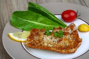 Pork schnitzel on the plate close up view photo