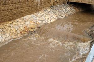 High concrete banks of a stormy river. photo