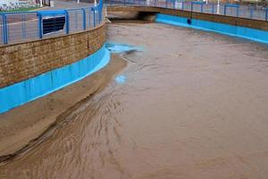 High concrete banks of a stormy river. photo