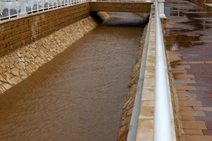 High concrete banks of a stormy river. photo