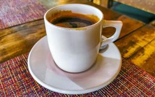 Cup of americano black coffee in restaurant Mexico. photo