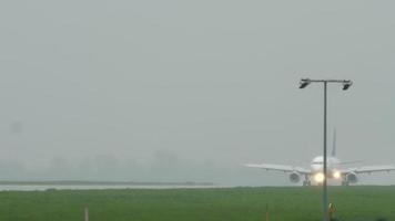 ALMATY, KAZAKHSTAN, MAY 4, 2019 - Airliner Air Astana slows down after landing at Almaty International airport in the rain video