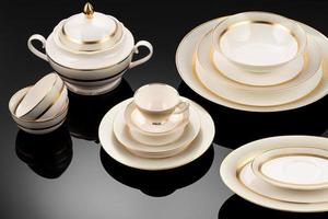 A luxury tableware set on black reflective surface photo