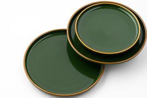 A set of green ceramic plates on a white background photo