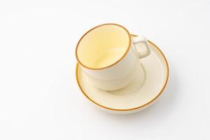 A set of white and brown ceramic plate and cup on a white background photo