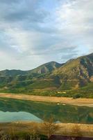 A vertical shot of the mountains and a reservoir in Central Asia photo