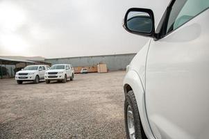 A closeup of an car door and rear view mirror at a construction site photo