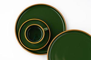 A set of dark green ceramic tableware with orange outlines photo