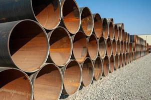 A line of oilfield large streel pipes in industrial construction area photo