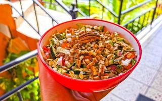 Bowl of salad with cucumber tomato greens broccoli Mexico. photo