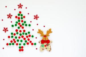 Flat lay of Christmas ornaments background set as pine tree shape. photo