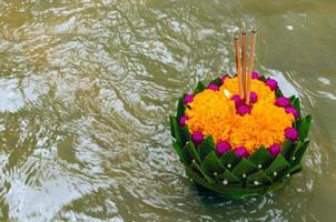 krathong de hoja de plátano flotando en el río para la luna llena de tailandia o el festival de loy krathong. foto