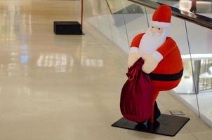 The big santa claus doll with red bag decorated for Christmas holiday. photo