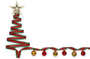 Christmas tree made from green and red color ribbon with star ornament on the top and colorful baubles isolated on white color background. photo