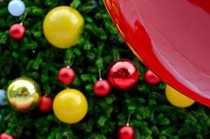 Christmas tree decorates with red, gold and smiling yellow baubles for Christmas holiday on December photo