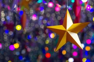 Colorful star ornaments hanging to decorate for Christmas holiday. photo