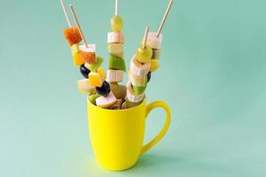 Fruit canape for a buffet in a cup. Sweet treats for a holiday, anniversary, birthday. photo