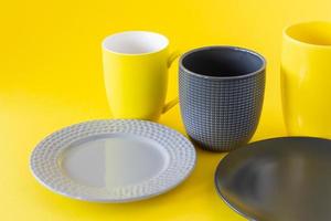 Set of crockery i trendy colors of the year 2021 - Ultimate grey and illuminating yellow. Kitchen utensils photo