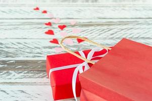 Festive greeting card for valentines day with red gift box and red paper bg. Copy space for text. photo
