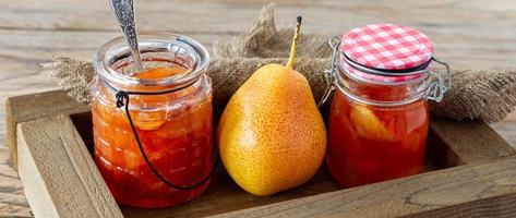 Homemade pear jam in wooden box on background fresh ripe pears photo