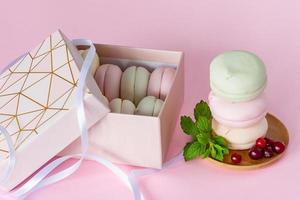 Gift box with homemade pastel multi color marshmallows. Apple zephyr in round shape. delicious fruit dessert on pink background photo