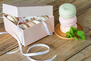 Gift box with homemade pastel multi color marshmallows. Apple zephyr in round shape. delicious fruit dessert on wooden table photo