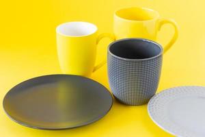 Set of crockery i trendy colors of the year 2021 - Ultimate grey and illuminating yellow. Kitchen utensils photo