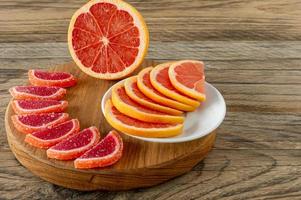 citrus jelly slices in sugar. marmalade slices of oranges and grapefruits on cutting board photo