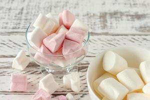 Assorted pink and white marshmallows in glass cups on wooden background. Heart shape marshmallow for hot chocolate or cacao photo