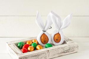 Easter Bunny ears made from napkins and eggs. Festive decoration for holiday photo