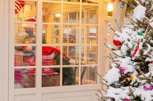 Moscow, Russia, 2020 - City christmas market pavillion next to festive decorated tree covered with snow photo