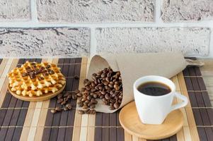 Two cups of freshly brewed espresso on wooden table. coffee beans on light wooden table, rustic style, homemade. photo