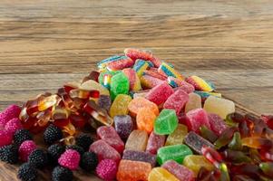 Fruit marmalade sweets, jelly candies on a wooden desk. Fruit natural dessert with sugar photo