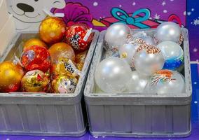 Moscow, Russia, 2020 - Toys at christmas market on display. Festive decoration for christmas tree. photo