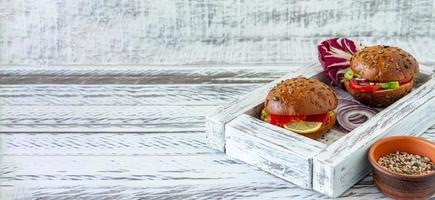 whole-grain bun stuffed with salad, salmon, avocado and tomatoes - freshly baked whole grain bun breakfast . Banner photo