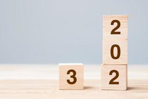 wooden cube block with 2023 text on table background. Resolution, plan, review, goal, start and New Year holiday concepts photo