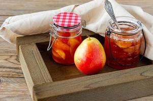 Homemade pear jam in wooden box on background fresh ripe pears photo