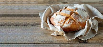 freshly baked bread on wooden gray kitchen table, homemade pastry. photo