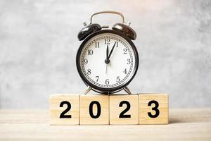 2023 text with clock on table. Resolution, time, plan, goal, motivation, reboot, countdown and New Year holiday concepts photo