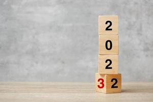 block flipping 2022 to 2023 text on table. Resolution, strategy, plan, goal, motivation, reboot, business and New Year holiday concepts photo