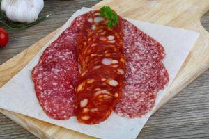 Salami sausage on wood photo