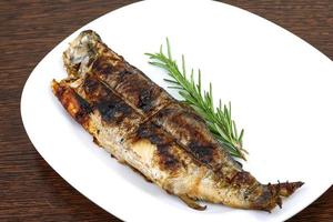 Grilled trout on wood photo