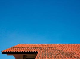The roof tiles of the building have a background of blue skies of bright sky. photo