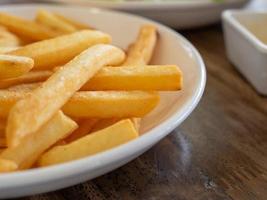 French fries are on a white plate. With copy space photo