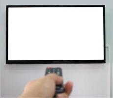 Empty TV screen  and the hand is holding the remote control to change the channel. photo